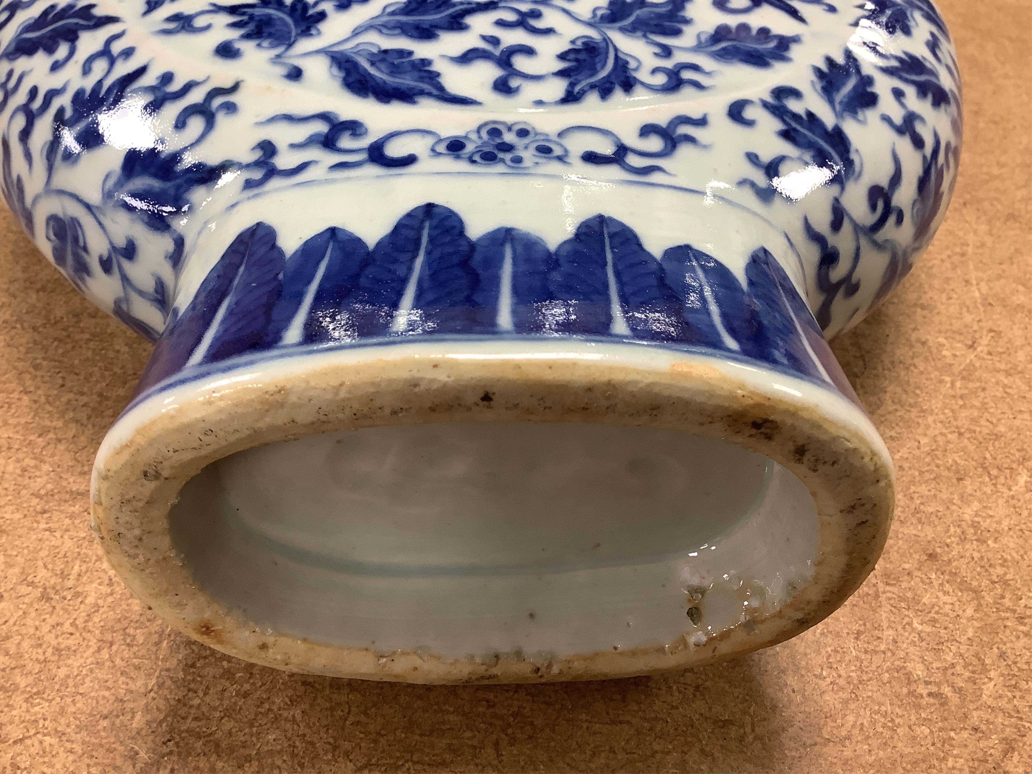 A 19th century Chinese blue and white moon flask on a hardwood stand, overall 35cm high. Condition - typical minor glaze imperfections